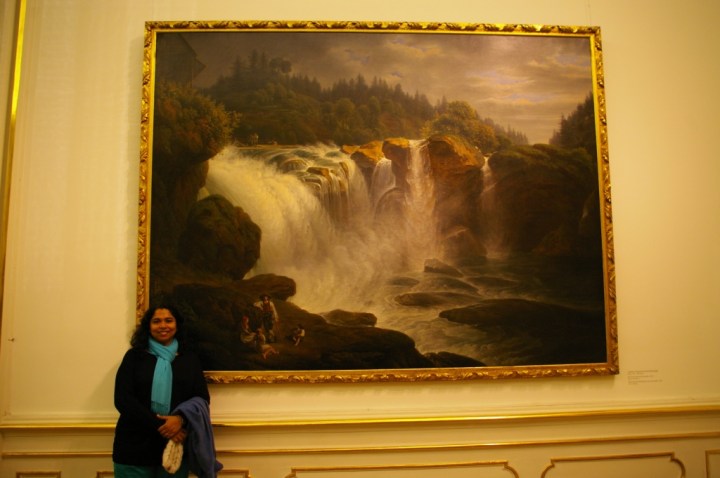 Fathima standing next to a painting she liked